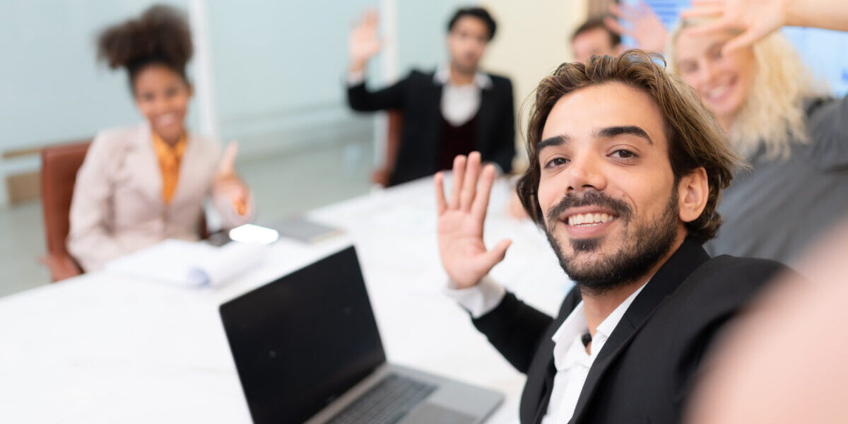 A diverse group of young business people taking selfies In the conference room